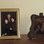 협탁 위 단란한 모습의 가족사진 두 장이 각각 액자에 담겨있다. 각각 감독의 지금 모습과 어린 시절 모습의 사진이다.
